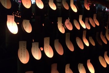 <p>Illuminated bamboo lanterns have personal wishes written on them</p>