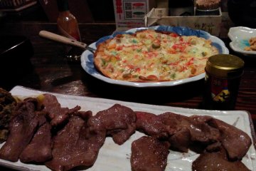 <p>Gyutan, a Sendai&nbsp;delicacy of cow tongue, with a side dish of pizza</p>