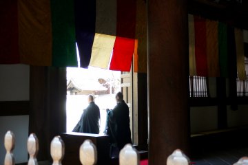 <p>Monks passing through the temple door</p>