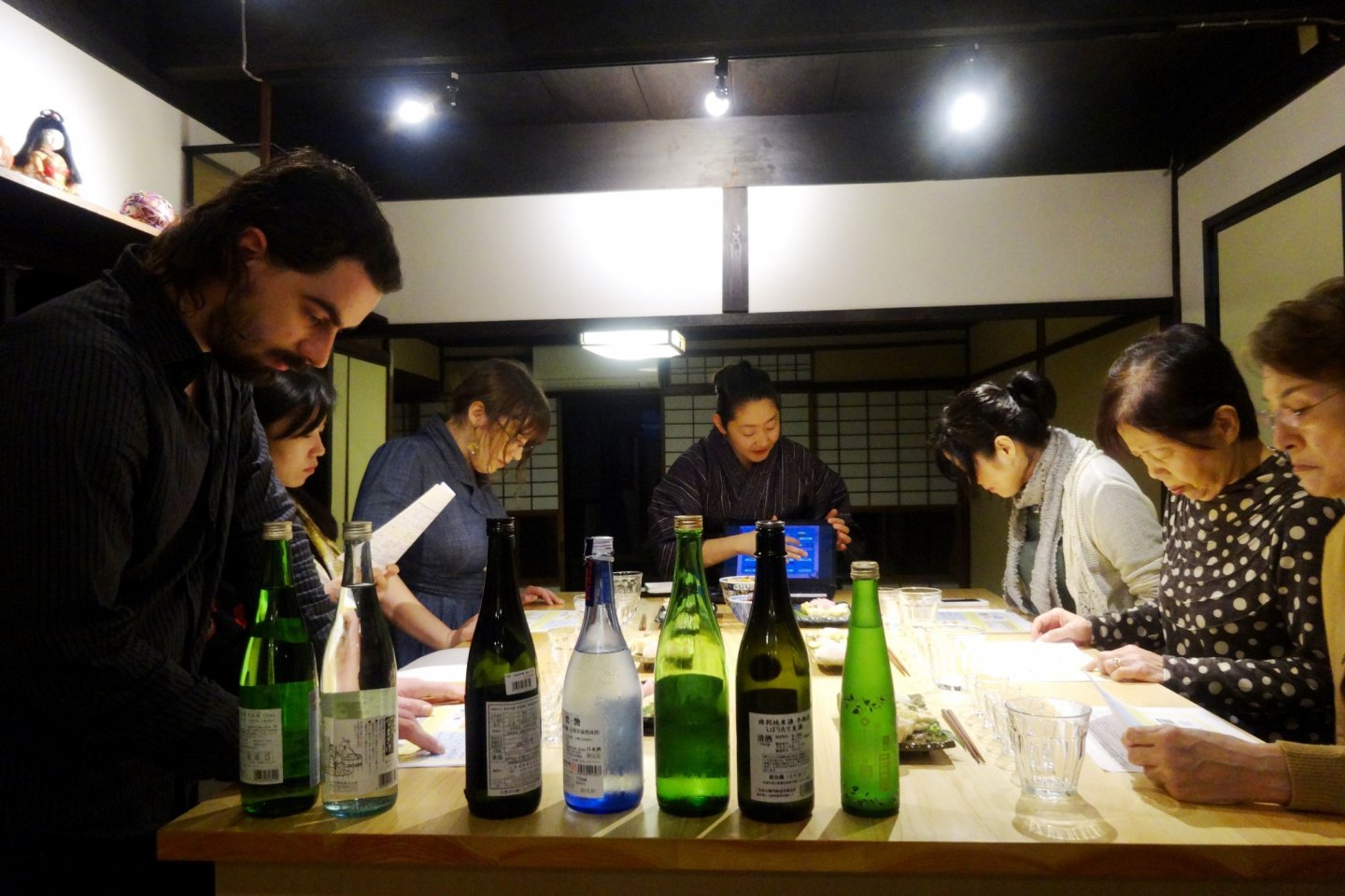 Sake bottles occupy a prominent position on the tasting table at Kafu's sake tasting workshop