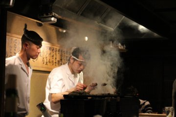 <p>Cooking in the back with the smoke escaping above</p>