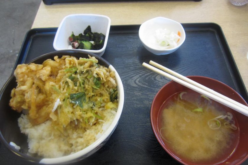 Deep-fried fish and onions on rice with miso soup and pickles