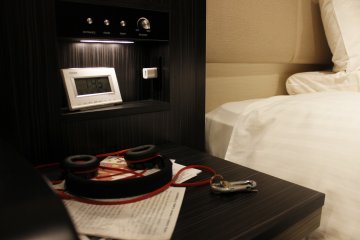 A nightstand with light controls and outlet