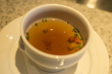 <p>This is Grand Hotel Special Consomm&eacute;, a delicate and delicious soup that really whets the appetite.</p>