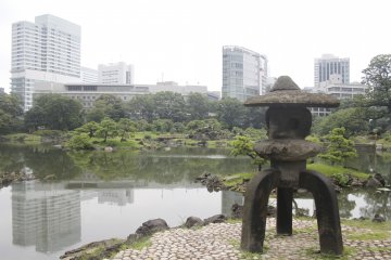An old lantern watches over an urban oasis.