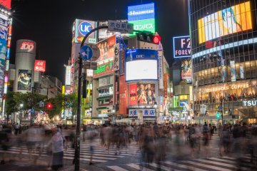 <p>People in motion crossing Shibuya Intersection</p>