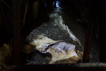 <p>The cave floor with running water in Irimizu.</p>