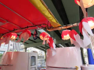 The delicate goldfish lanterns, a traditional Japanese folk art, are hanged all around the boat.