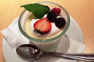 A delicious selection of small desserts, including panna cotta topped with summer berries.