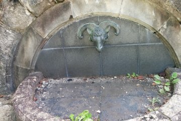 <p>A memrorial goat head fountain</p>