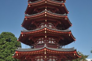 An imposing pagoda amid other majestic buildings
