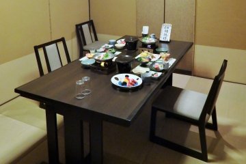 <p>Our dinner was served at a regular table with chairs.</p>