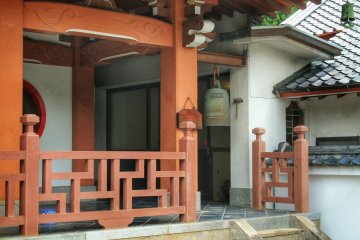 A small temple bell is on the right of the main building

