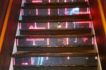<p><span style="line-height: 20.8px;">The neon staircase transport visitors to the bar on the upper level.</span></p>
