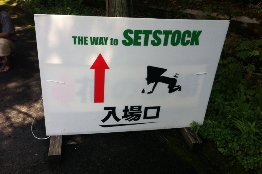 Welcome to Setstock, I\'m not sure what the guy on the sign is doing, answers on the back of a postcard