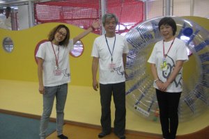 Staff in front of a clear rolling wheel that kids older than three can try out