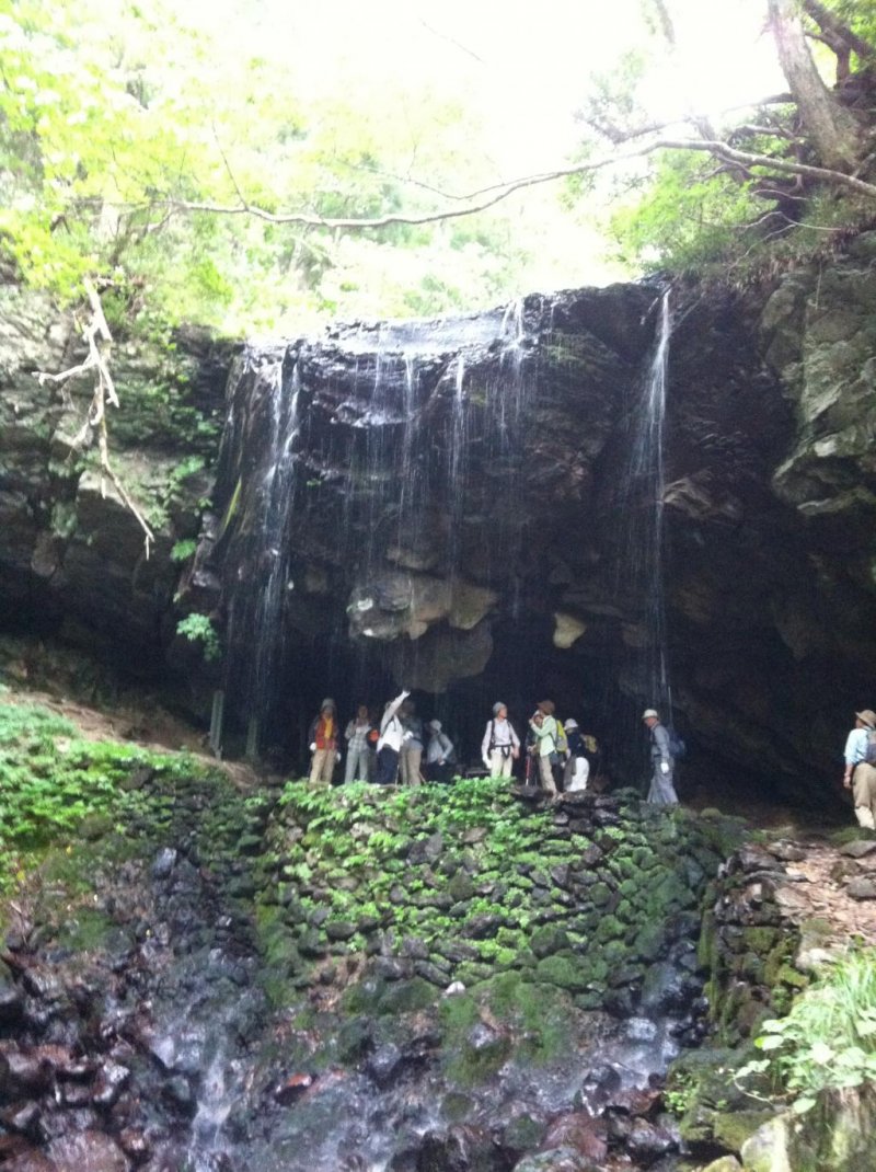 People gathered inside the waterfall