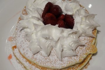 <p>Strawberry pancakes with a healthy dollop of whipped cream</p>
