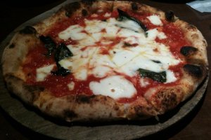 Pizza Margherita pulled right from the fire brick oven.
