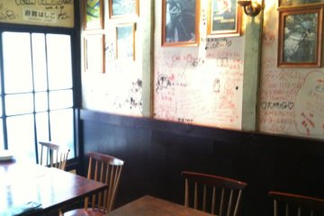 Corner seats by the window. Notice the writing on the wall. You can write too.