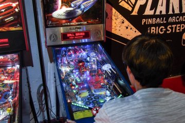 Battling it out at the tournament over some Star Wars pinball.