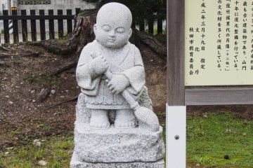 One of the sweeping monk statues at the temple.