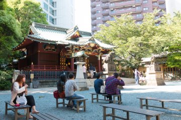 People taking a break at the shrine and using it as a meeting place