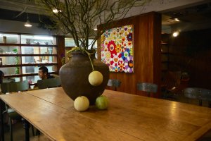 The cafe/bar is mixture between quirky, colorful art and modern, earthy furniture 
