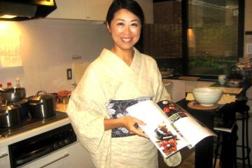 Kaori uses her collection of cooking and culture books to explain Japanese Cuisine