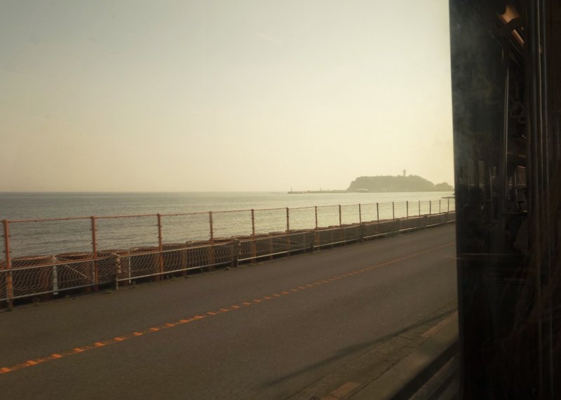 Here you can see the island of Enoshima getting closer, as I'm riding on the Enoden train from Kamakura