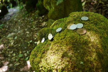 Посетители оставляют монетки на головах статуй на удачу