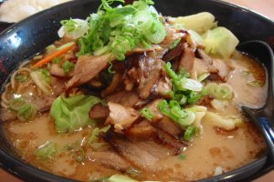 Premium pork ramen with tonkotsu (pork bone) stock and handmade noodles, Topped with thin tender slices of pork belly, cabbage, green onions, slivered carrots