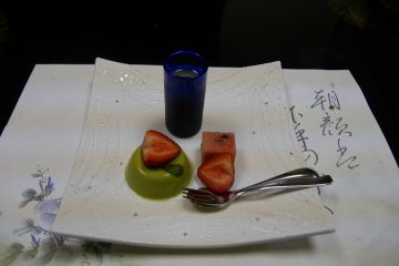 Macha pannacotta topped with strawberry pieces.