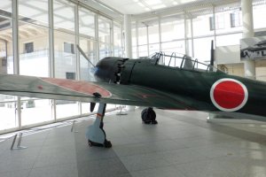 An A6M Zero Model 52 fighter jet is one of the many war machines on display.