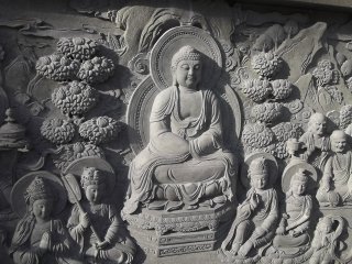 A relief carving below one of the statues