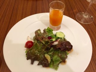 A freshly squeezed juice and salad