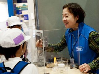 A museum operator shows an experiment