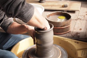 An artisan creates a pot with the ease of a master