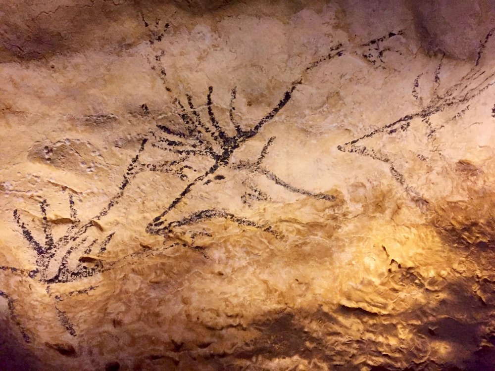 A cave painting of swimming deers