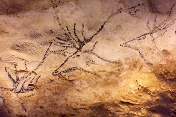 A cave painting of swimming deers