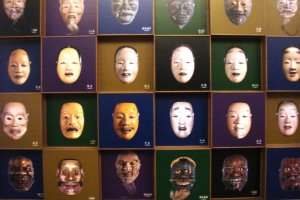 Panel that shows different Noh masks at the Kurokawa Noh Museum