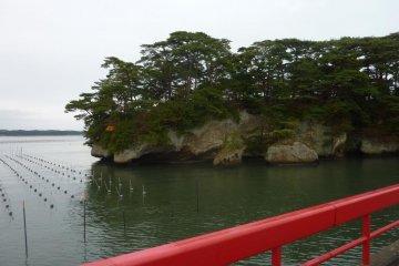 <p>View of Fukuura Island over the side of its red bridge</p>