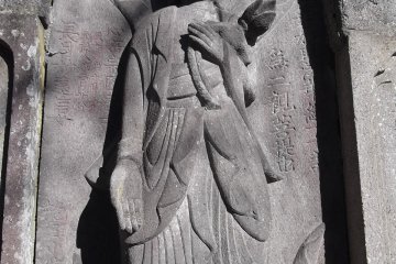 One of the carved figures on the big grave