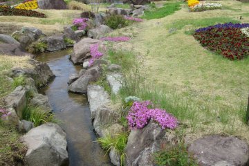 "River" decorated with stones and flowers