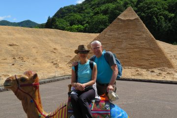 Rey and Miwa on camel in front of Pyramid