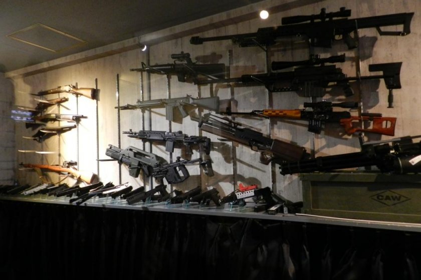 The guns along the wall of the shooting range