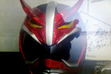 Red Autographed Kamen Rider or Gundam Like Manga Cosplay Masks the size of Motorbike helmets at the Akita Design Hub and Handicraft Center
