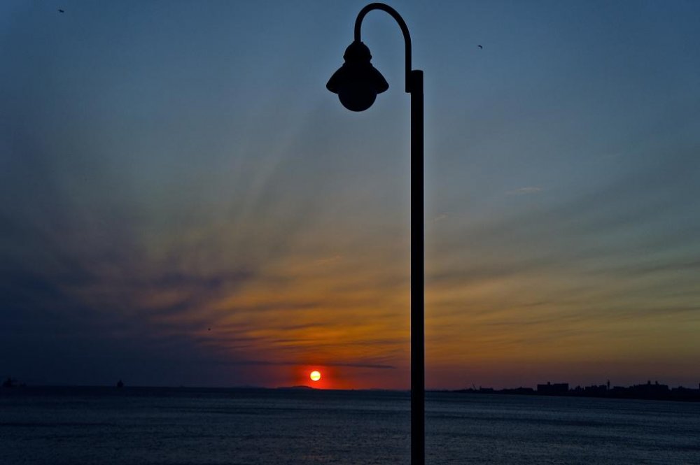 Beachfront lamppost silhouette