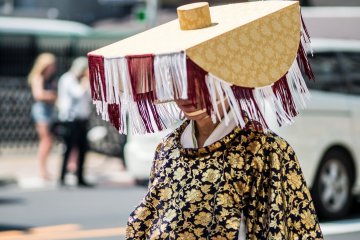 This local walks the street in traditional costume as part of a parade