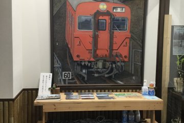 A member of the NPO paints these amazingly detailed photorealistic train scenes.